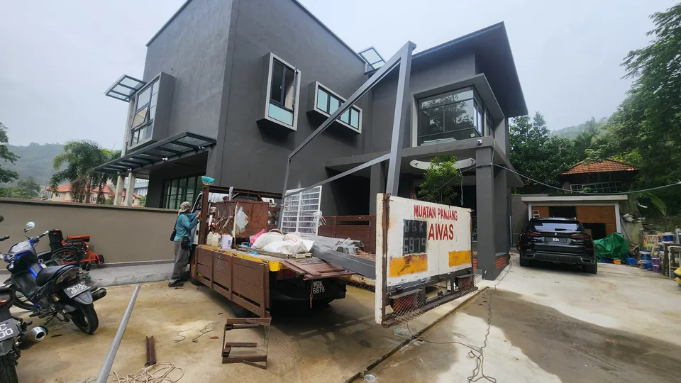 Equipment and materials outside a house during installation work.