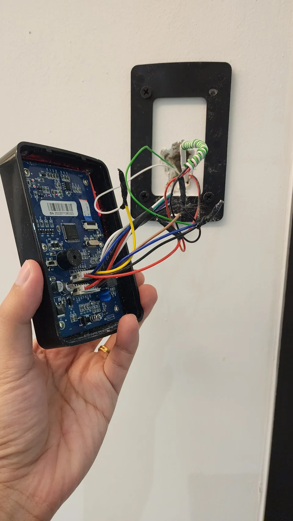 Multimeter testing exposed access-control wiring.