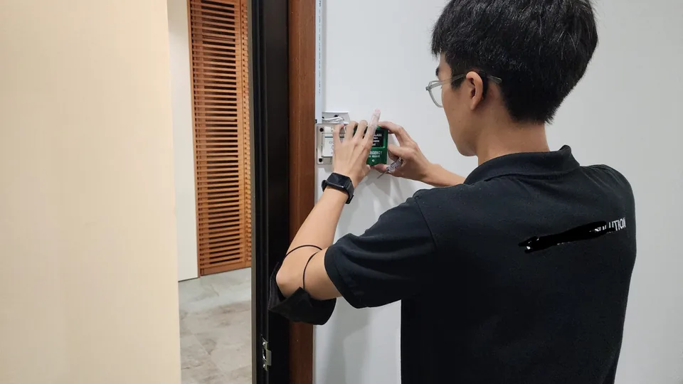 Technician connecting wall reader wiring.